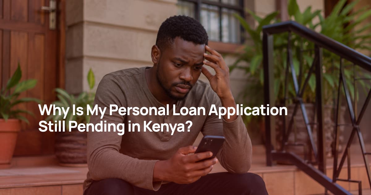 Kenyan man sitting on the steps of his home checking the status of his personal loan application on his phone.