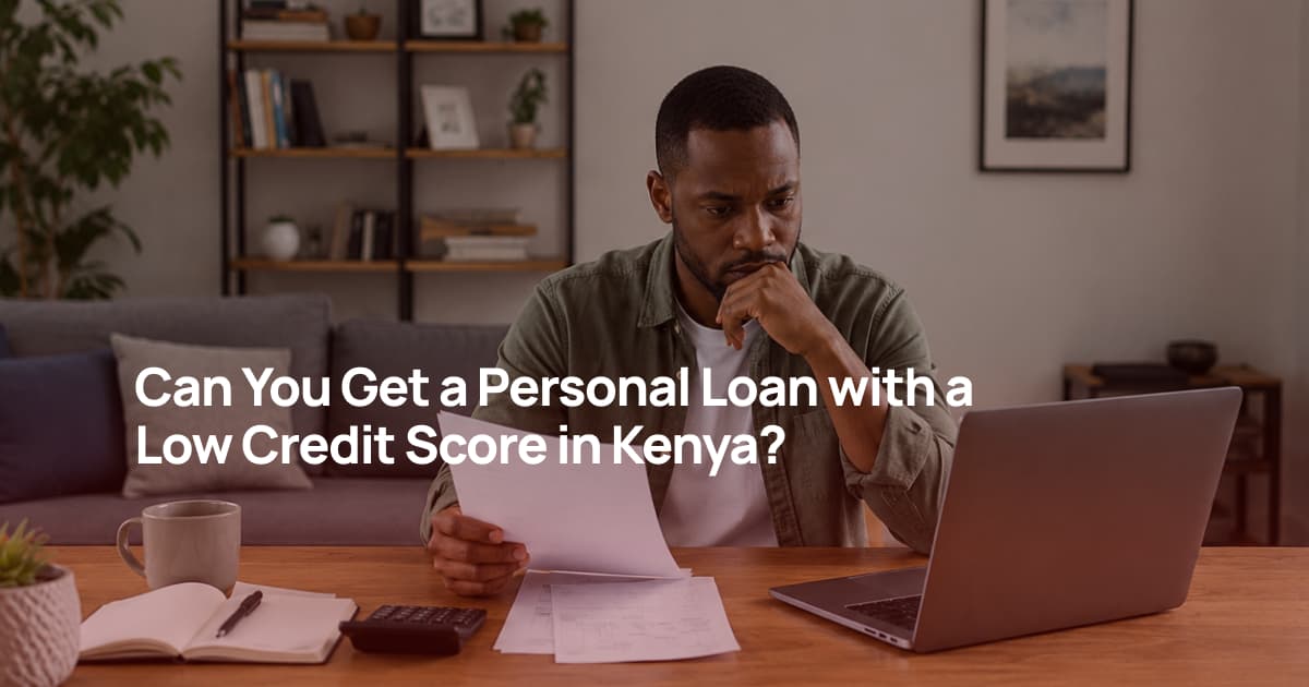 A Kenyan man reviewing his credit information on a laptop while preparing a personal loan application at home.