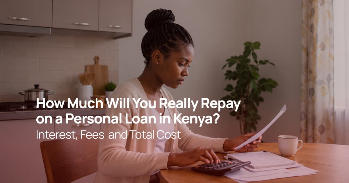 Kenyan woman calculating personal loan repayments using a calculator and financial documents at her kitchen table.